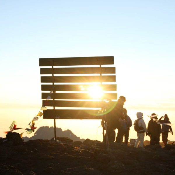 Kili summit sign at sunrise, mount kilimanjaro, mountain climbing in africa