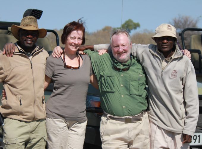 50+ travellers couple with safari guides