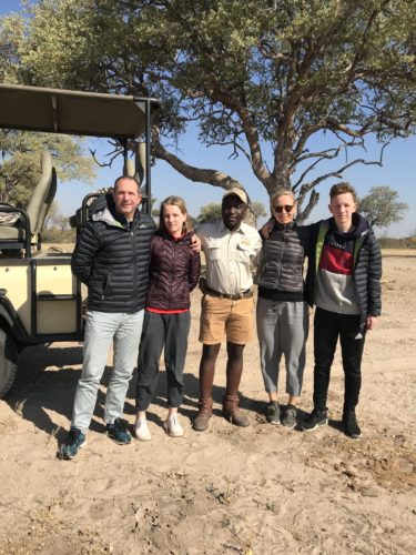 Quinn family on safari with guide and vehicle 2019