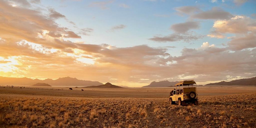 Wolwedans Namibia desert setting 4x4 vehicle sunset