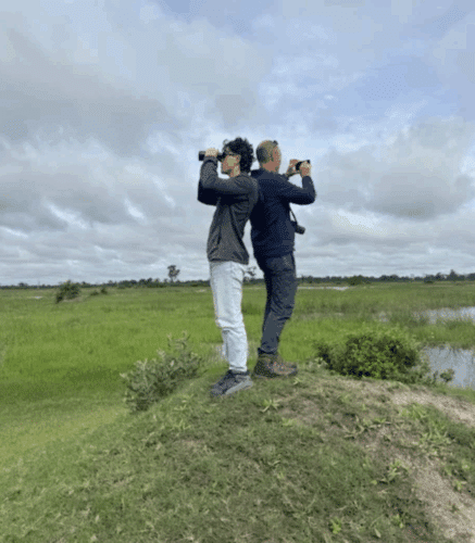 Donsante family safari holiday Botswana safari father and son looking out with binoculars