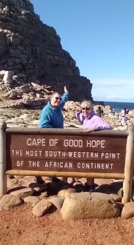 Rachel and Paddy holiday LGBTQIA+ Kenya Victoria Falls gay couple cape point sign South Africa