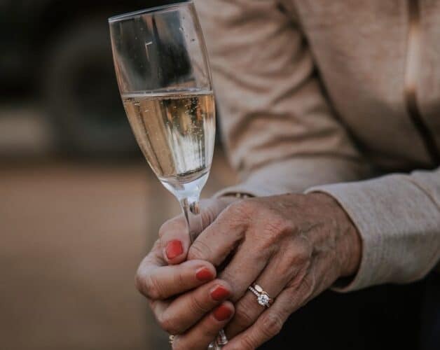 lady with champagne glass elderly lady with ring wedding anniversary luxury safari South Africa Tanda Tula