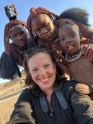 Danica and himba selfie fascinated by children with blonde hair and ginny no kids Visiting a himba village from Hoanib Valley Camp Kaokoland with Natural Selection Travel Danica Wilson 2023