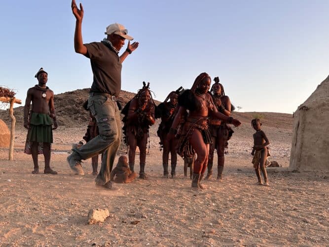 Ramon our guide dancing with himba Visiting a himba village from Hoanib Valley Camp Kaokoland with Natural Selection Travel Danica Wilson 2023